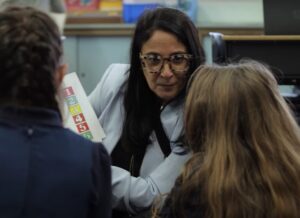 Ronit, Ron-Yerushalmi, Director of Language and Global Studies at Kavod Charter School Reading Book to Students