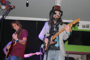 Mr. Kessler (left) and Mr. Lancaster (right) rocking out on stage with their guitars at the Humble Heart in Ocean Beach.