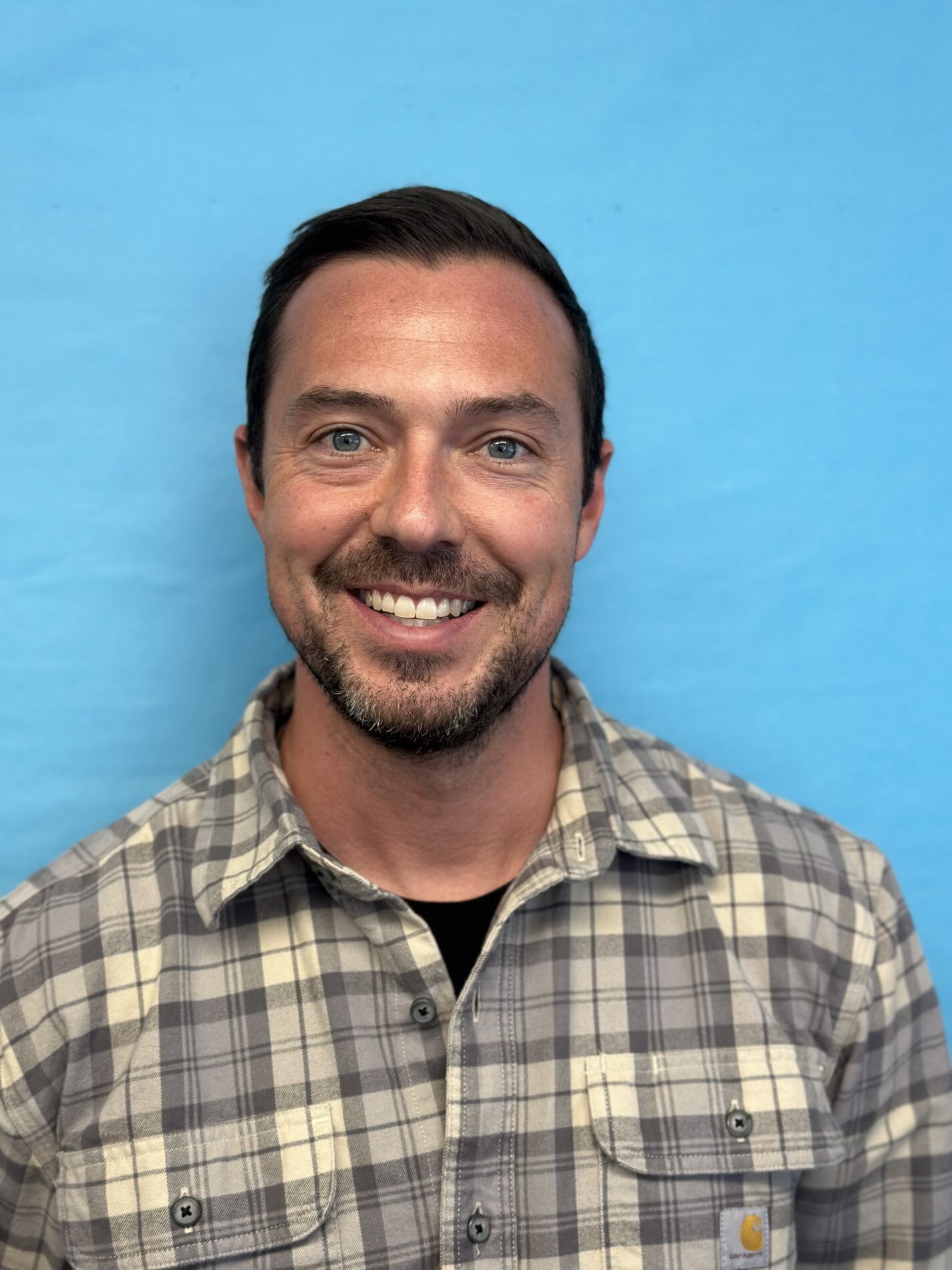 Headshot of Mr. St. Hilaire, Kavod 5th Grade Teacher, in front of a blue background.