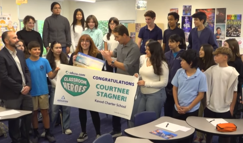 Kavod teacher Ms. Stagner photographer with her students as she is honored with "Classroom Hero" award.