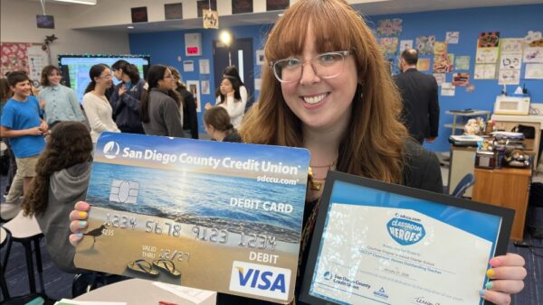 Ms. Stagner holds SDCCU debit card and award certificate