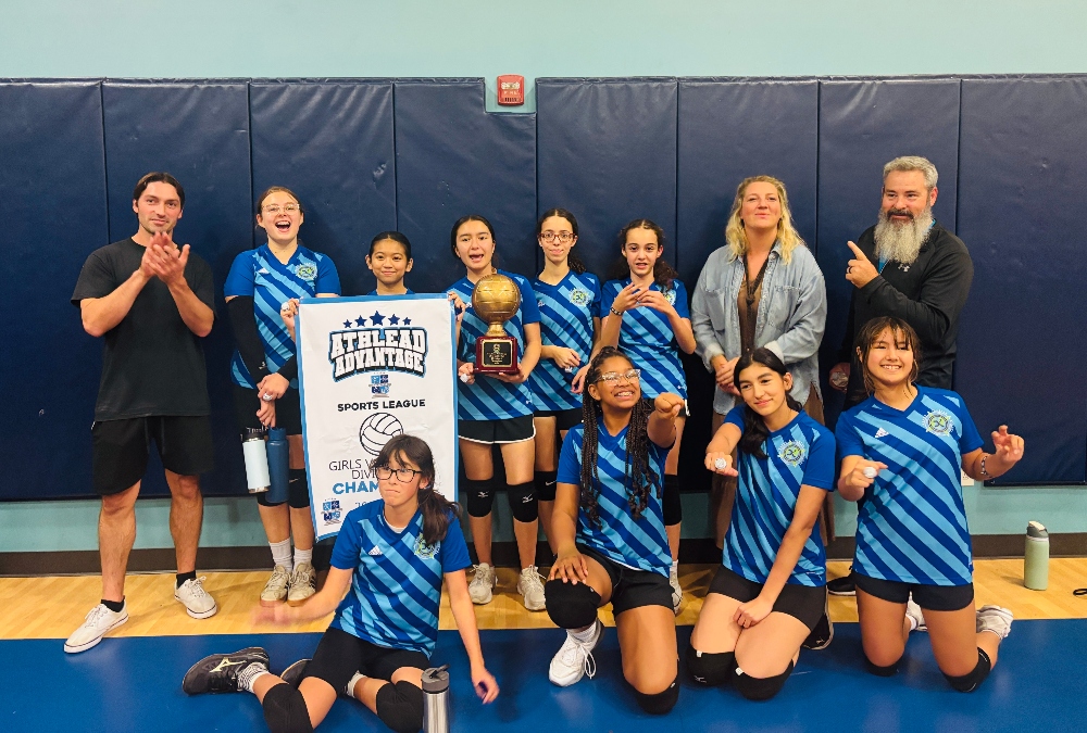 Kavod Charter School volleyball team posing with trophy