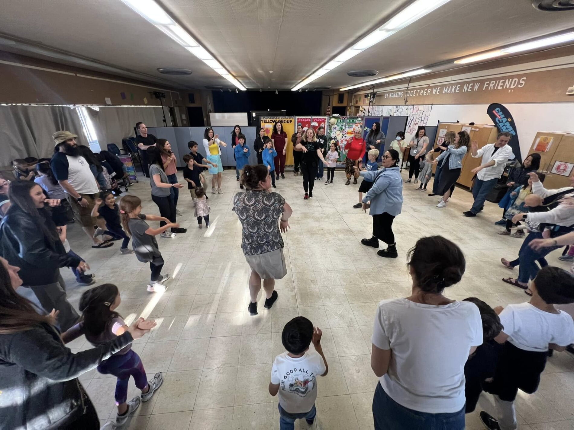 Kavod families dance at an Israeli Dance Party, 2024.