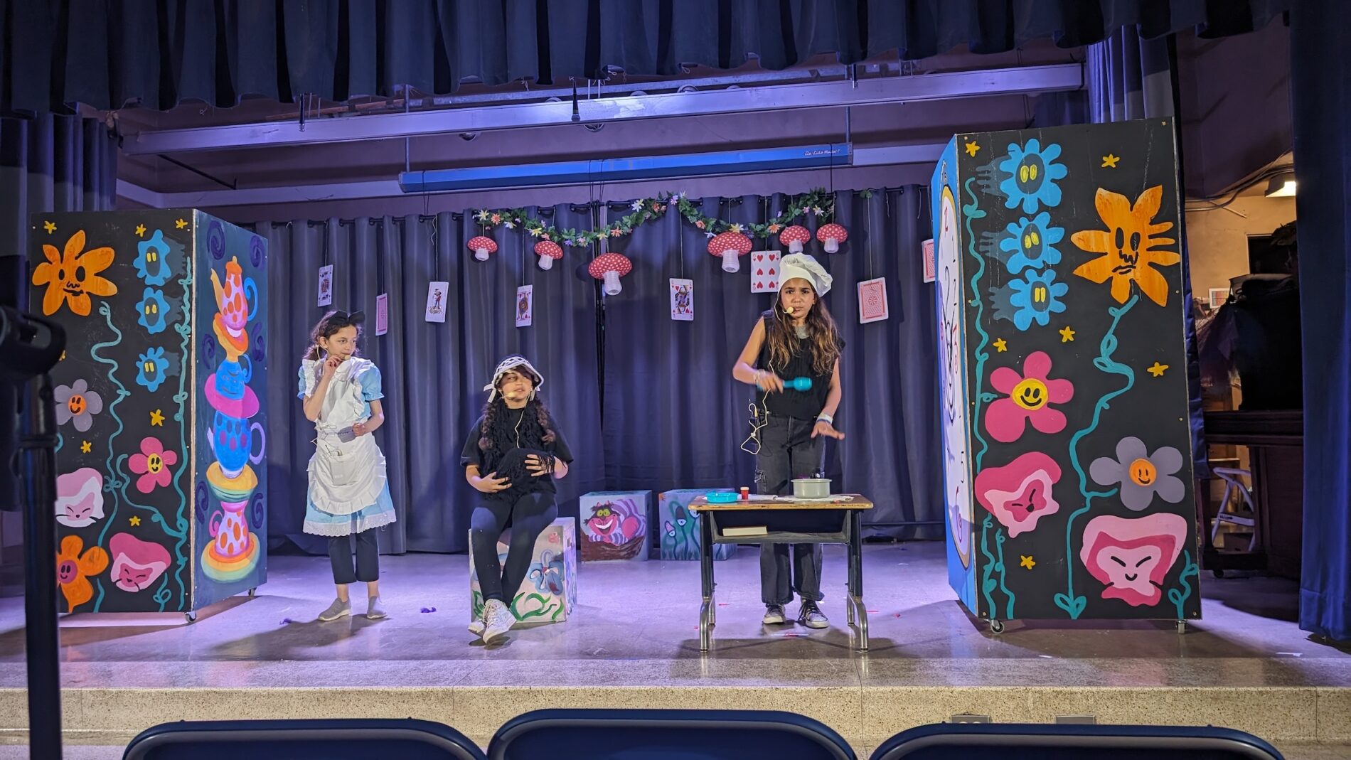 Kavod students on stage, performing on stage a play.